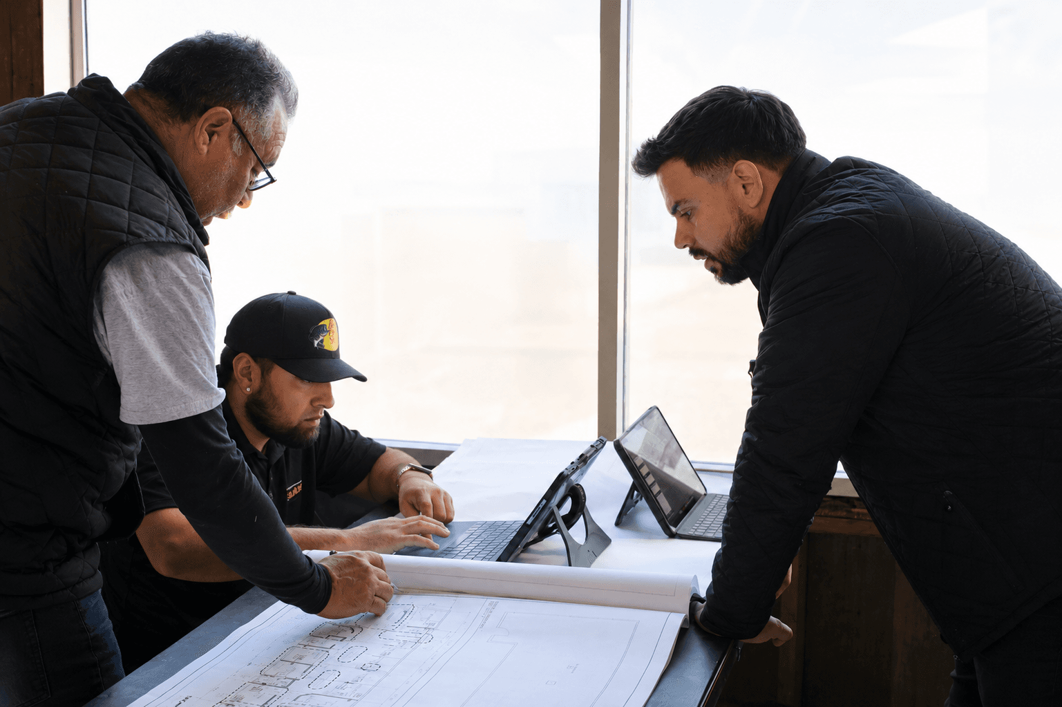 SE Builders team reviewing plans on site
